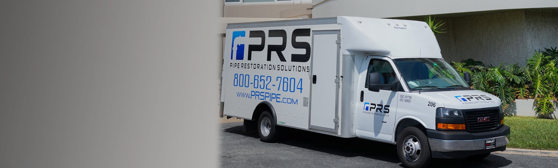 PRS truck parked in front of a condo for roof vent pipe repair