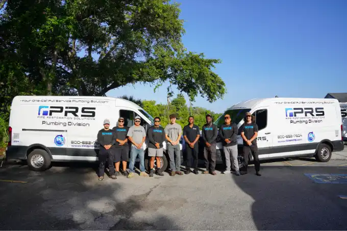 PRS plumbing division standing in front of work vehicles in Sarasota, FL