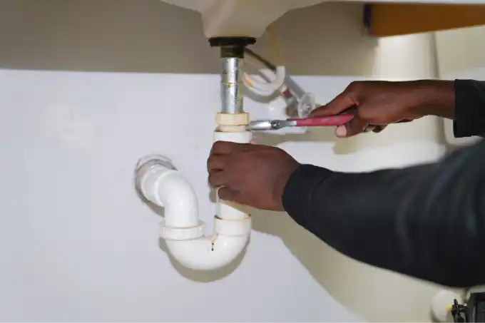 PRS technician performing plumbing repairs in Sarasota, FL